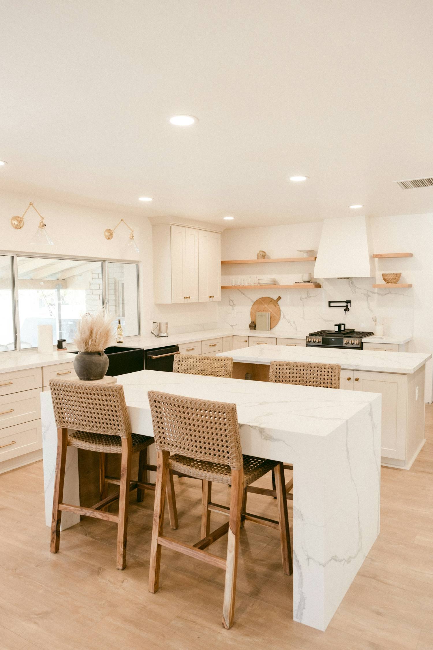 Newly remodeled kitchen with white oak cabinets and a quartz island