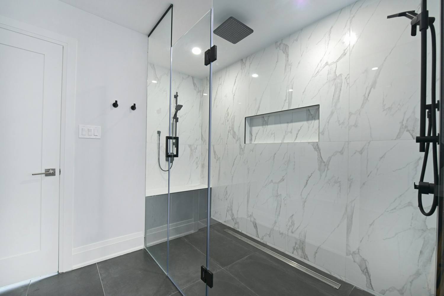 Remodeled bathroom with a glass-enclosed walk-in shower