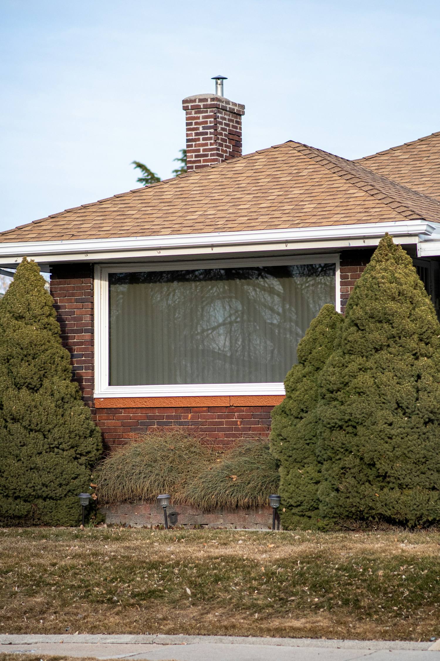 Brick house exterior with trees in front